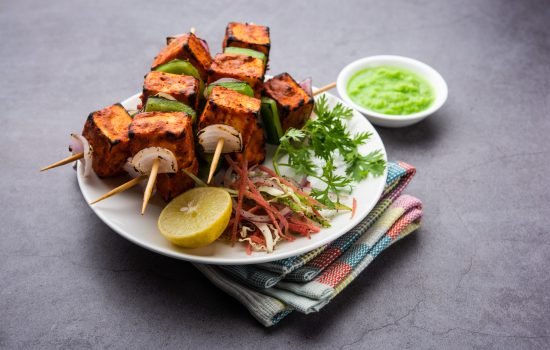 Paneer tikka is an Indian dish made from chunks of cottage cheese marinated in spices and grilled in a tandoor