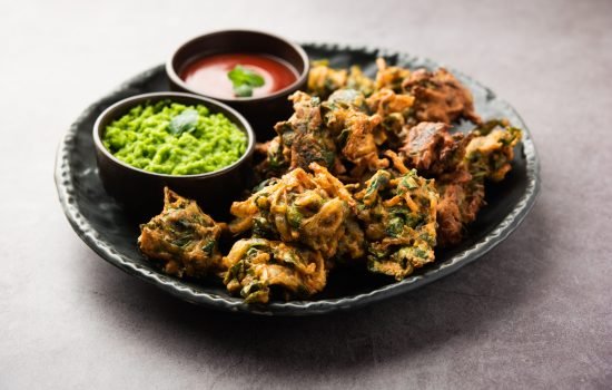 Homemade tasty Palak pakoda or pakora known as Spinach Firtters, served with ketchup. Favourite Tea-time snack from India